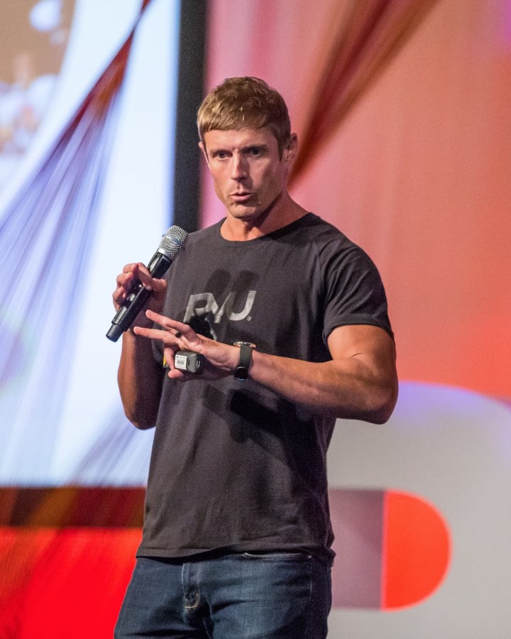 Dai Manuel speaking on stage in front of an audience